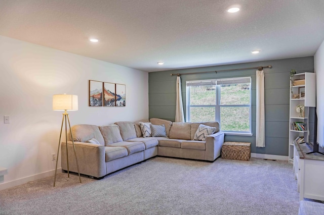 living room with recessed lighting, a textured ceiling, and light colored carpet