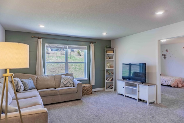 carpeted living area with recessed lighting and a textured ceiling