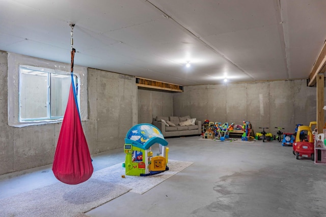 playroom featuring concrete flooring