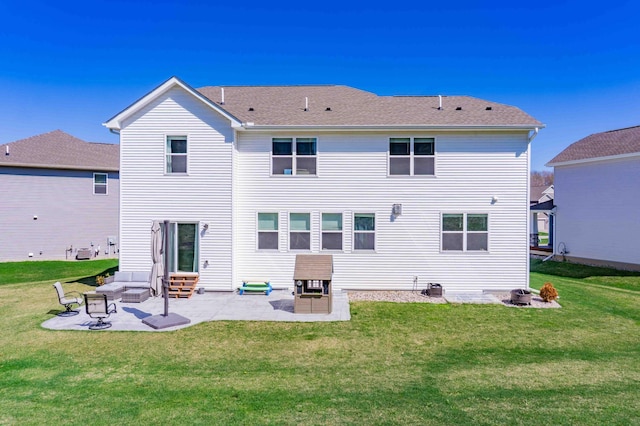rear view of house featuring a lawn, a patio, and entry steps