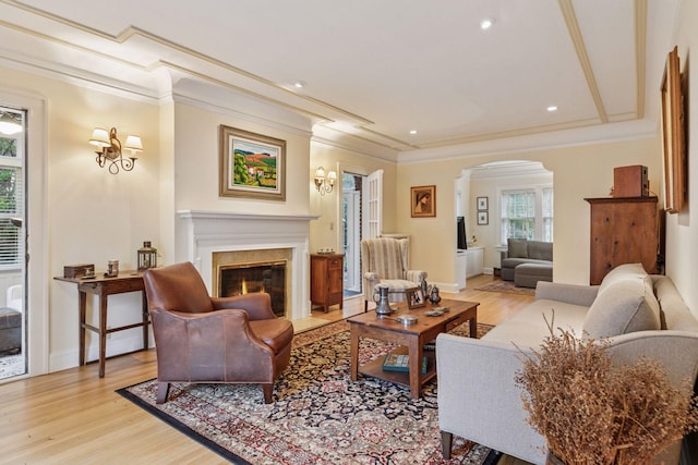 26 Mississippi River Blvd N, Saint Paul, MN 55104 - living area with arched walkways, light wood-style flooring, a premium fireplace, ornamental molding, and recessed lighting