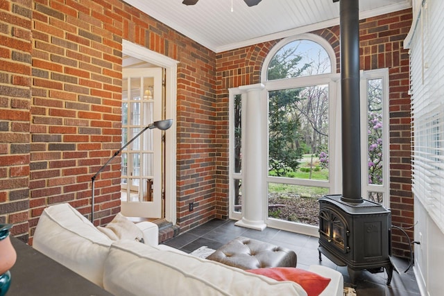 26 Mississippi River Blvd N, Saint Paul, MN 55104 - tiled living room with a wood stove, brick wall, and ceiling fan