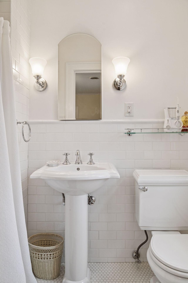 26 Mississippi River Blvd N, Saint Paul, MN 55104 - bathroom featuring tile walls, toilet, tile patterned floors, and a wainscoted wall