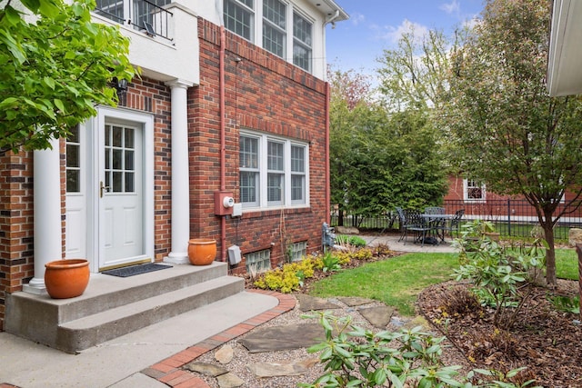 26 Mississippi River Blvd N, Saint Paul, MN 55104 - view of exterior entry with brick siding, fence, and a patio area