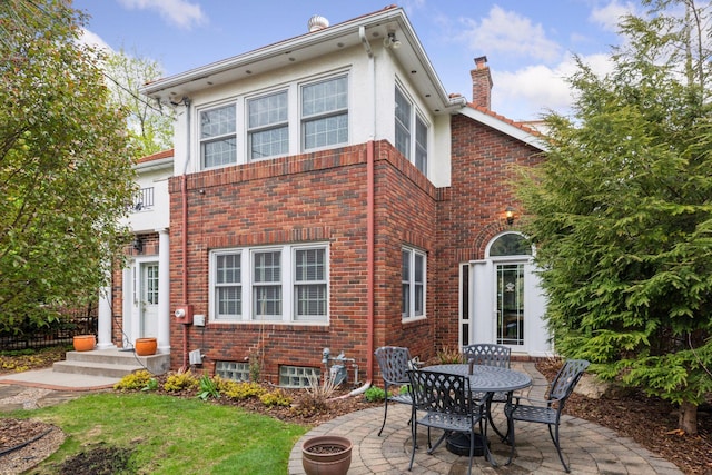 26 Mississippi River Blvd N, Saint Paul, MN 55104 - rear view of property with a patio area, a chimney, brick siding, and stucco siding