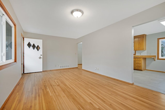 1034 Birch St, Lino Lakes, MN 55014 - empty room with baseboards, light wood finished floors, and visible vents