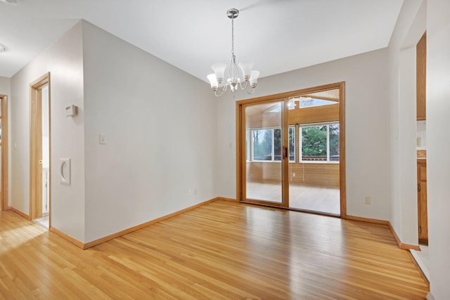 1034 Birch St, Lino Lakes, MN 55014 - spare room with baseboards, a notable chandelier, and light wood-type flooring