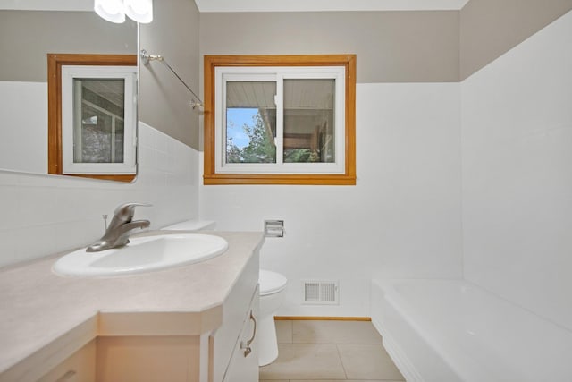 1034 Birch St, Lino Lakes, MN 55014 - full bath with visible vents, tile patterned flooring, vanity, toilet, and a bathing tub