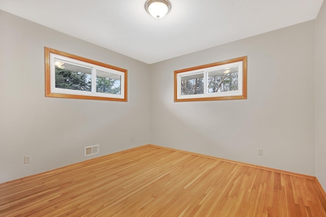 1034 Birch St, Lino Lakes, MN 55014 - spare room with visible vents, baseboards, and wood finished floors