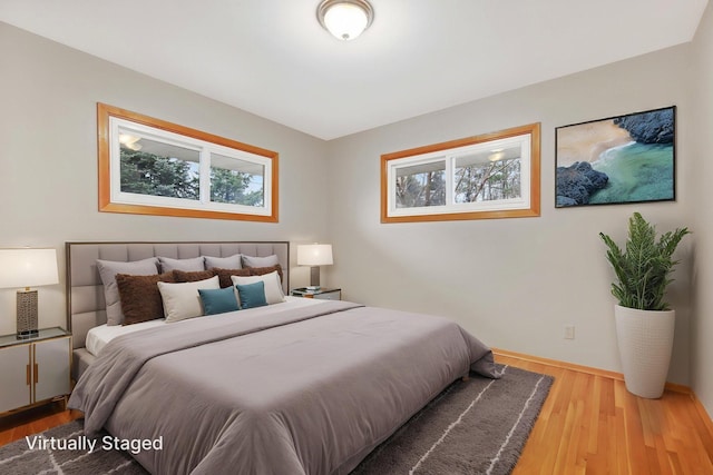 1034 Birch St, Lino Lakes, MN 55014 - bedroom featuring baseboards, wood finished floors, and multiple windows