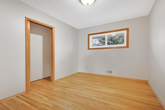 1034 Birch St, Lino Lakes, MN 55014 - spare room with visible vents and wood finished floors