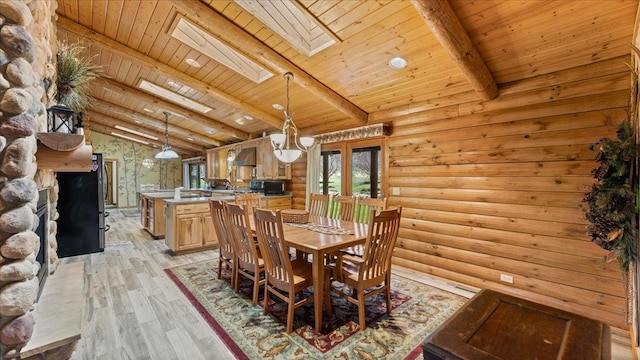 18100 Stockhousen Rd NW, Evansville, MN 56326 - dining room featuring light wood finished floors, a fireplace, vaulted ceiling with skylight, french doors, and wood ceiling
