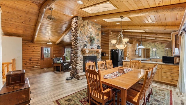 18100 Stockhousen Rd NW, Evansville, MN 56326 - dining space with wooden ceiling, log walls, light wood-style flooring, and a fireplace