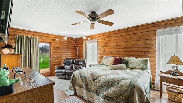 18100 Stockhousen Rd NW, Evansville, MN 56326 - bedroom with access to outside, a textured ceiling, ceiling fan, and light wood-style flooring