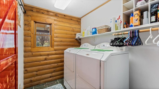 18100 Stockhousen Rd NW, Evansville, MN 56326 - laundry area featuring laundry area, a textured ceiling, washing machine and clothes dryer, tile patterned flooring, and wood walls