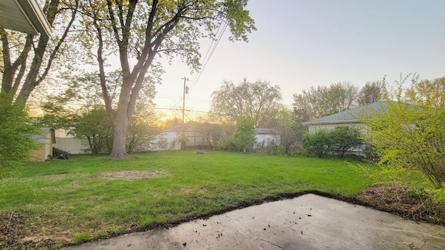 view of grassy yard with a patio
