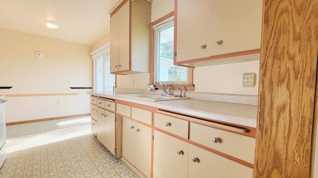 kitchen featuring a sink and light countertops