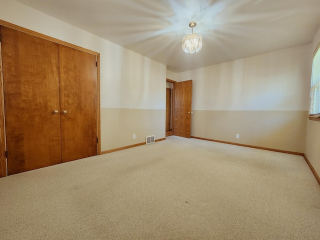 unfurnished bedroom with carpet flooring, baseboards, and a closet
