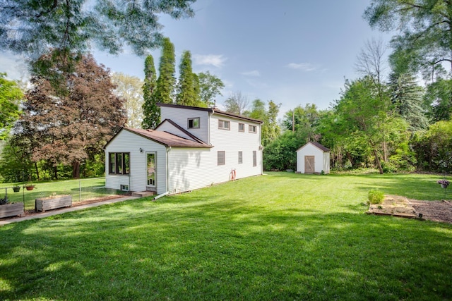 5371 Hugo Rd, White Bear Twp, MN 55110 - back of house with a lawn, a vegetable garden, and view of scattered trees