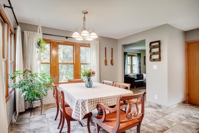 5371 Hugo Rd, White Bear Twp, MN 55110 - dining room featuring a chandelier and baseboards