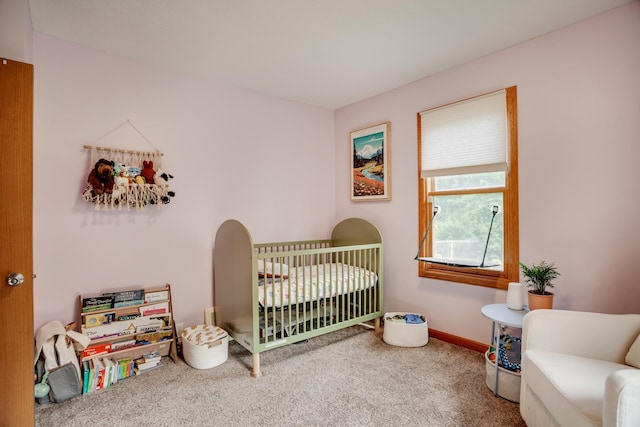 5371 Hugo Rd, White Bear Twp, MN 55110 - carpeted bedroom featuring a nursery area and baseboards
