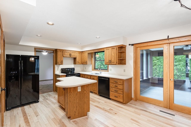 8762 Highwood Way, Apple Valley, MN 55124 - kitchen with black appliances, light wood-style flooring, open shelves, a center island, and light countertops