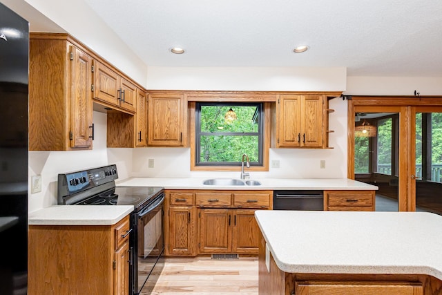 8762 Highwood Way, Apple Valley, MN 55124 - kitchen featuring black appliances, light countertops, a sink, brown cabinetry, and recessed lighting
