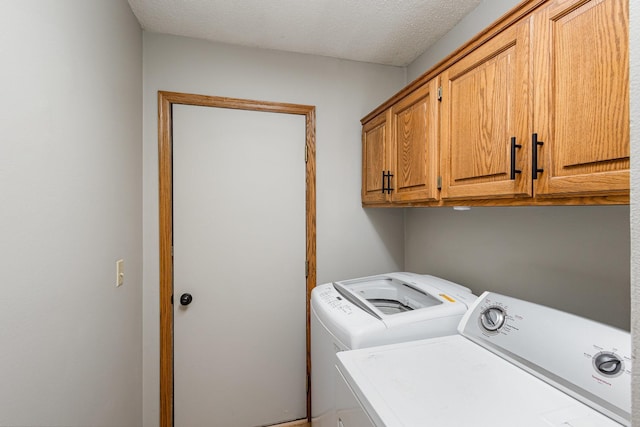8762 Highwood Way, Apple Valley, MN 55124 - laundry room featuring washing machine and clothes dryer, cabinet space, and a textured ceiling