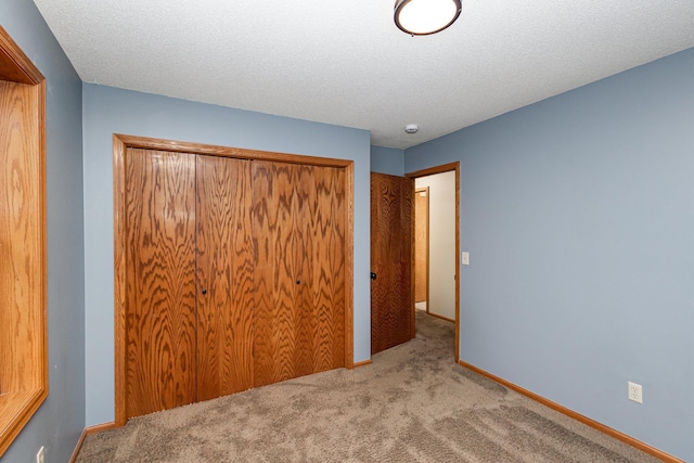8762 Highwood Way, Apple Valley, MN 55124 - unfurnished bedroom featuring carpet floors, a closet, baseboards, and a textured ceiling