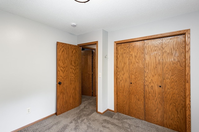 8762 Highwood Way, Apple Valley, MN 55124 - unfurnished bedroom with carpet floors, a closet, baseboards, and a textured ceiling