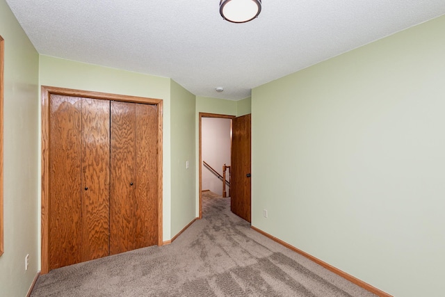 8762 Highwood Way, Apple Valley, MN 55124 - unfurnished bedroom with a closet, light carpet, a textured ceiling, and baseboards