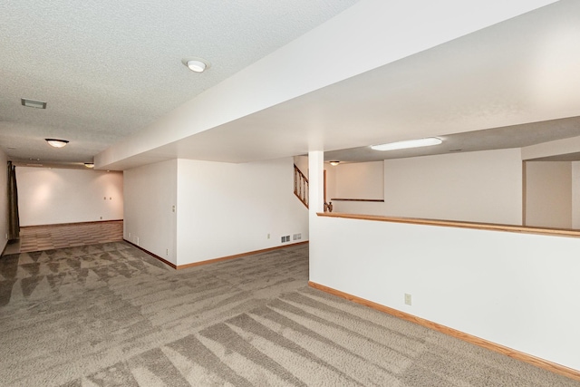 8762 Highwood Way, Apple Valley, MN 55124 - finished below grade area featuring carpet floors, a textured ceiling, and baseboards