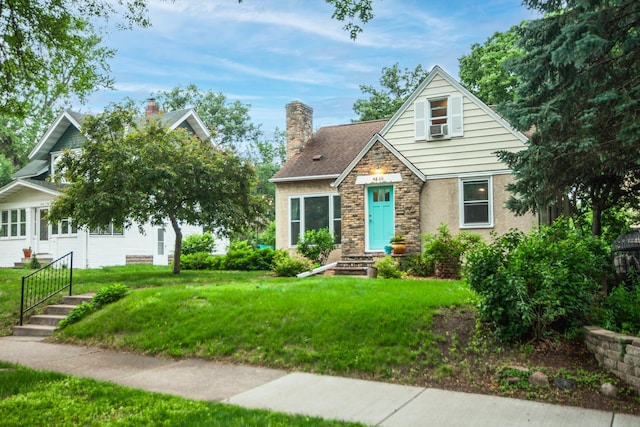 4830 29th Ave S, Minneapolis, MN 55417 - view of front of property featuring stone siding, a front lawn, and a chimney