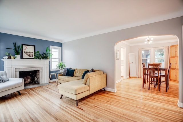 4830 29th Ave S, Minneapolis, MN 55417 - living area featuring arched walkways, a chandelier, plenty of natural light, and light wood-style flooring