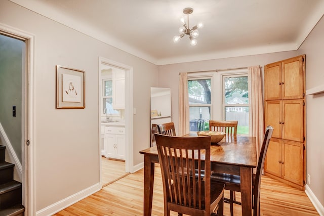 4830 29th Ave S, Minneapolis, MN 55417 - dining area featuring light wood-style floors, a chandelier, and stairway