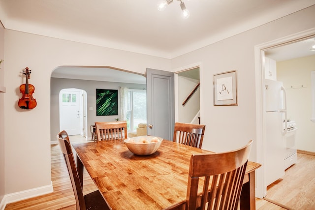 4830 29th Ave S, Minneapolis, MN 55417 - dining room featuring arched walkways, light wood-type flooring, and stairs