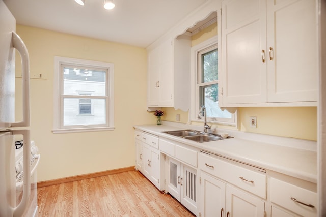 4830 29th Ave S, Minneapolis, MN 55417 - kitchen with freestanding refrigerator, white cabinetry, light wood finished floors, and light countertops