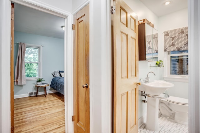 4830 29th Ave S, Minneapolis, MN 55417 - half bath featuring toilet and wood finished floors