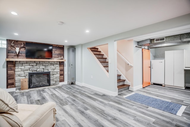 4830 29th Ave S, Minneapolis, MN 55417 - living room with light wood-style flooring, recessed lighting, stairway, and a stone fireplace