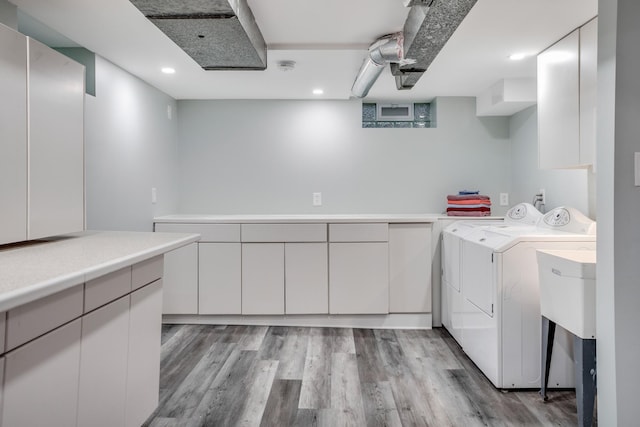 4830 29th Ave S, Minneapolis, MN 55417 - laundry room with cabinet space, independent washer and dryer, light wood finished floors, and recessed lighting