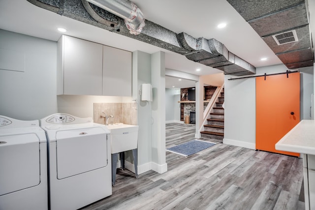 4830 29th Ave S, Minneapolis, MN 55417 - laundry room featuring light wood finished floors, a stone fireplace, washing machine and clothes dryer, and recessed lighting