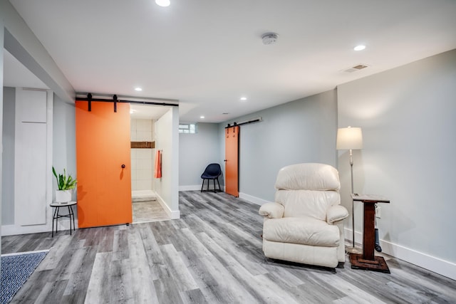 4830 29th Ave S, Minneapolis, MN 55417 - living area featuring a barn door, wood finished floors, and recessed lighting