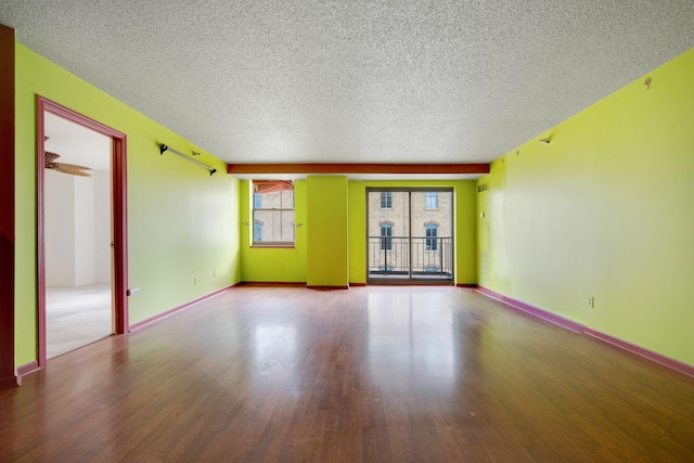 401 1st St Unit 401, Minneapolis, MN 55401 - spare room featuring wood finished floors, a textured ceiling, and baseboards