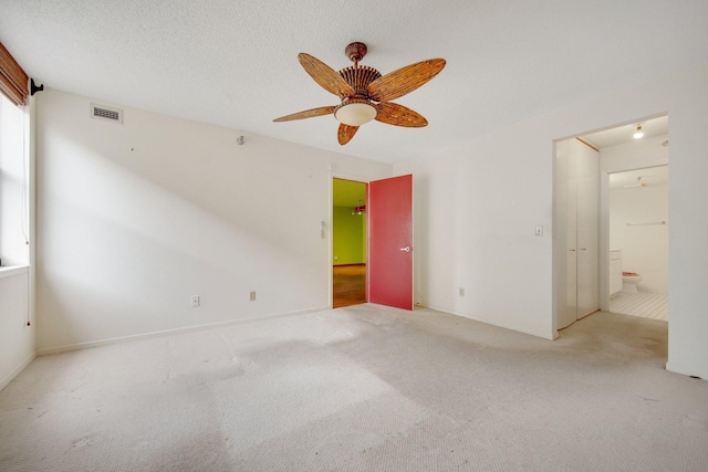 401 1st St Unit 401, Minneapolis, MN 55401 - unfurnished bedroom featuring carpet, connected bathroom, and ceiling fan