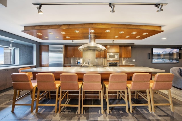 401 1st St Unit 401, Minneapolis, MN 55401 - kitchen featuring built in appliances, track lighting, light countertops, brown cabinets, and recessed lighting