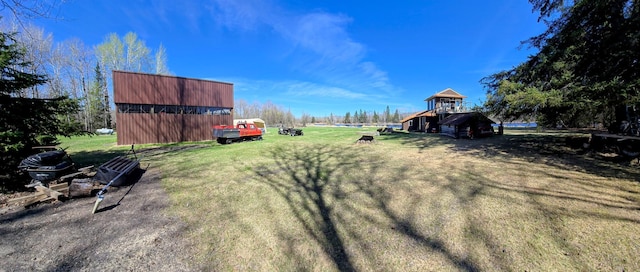view of green lawn with an outbuilding