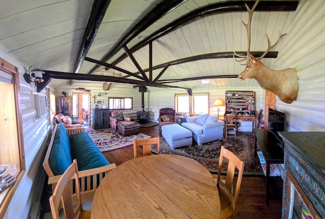 dining room featuring a wood stove, wood finished floors, and wooden ceiling