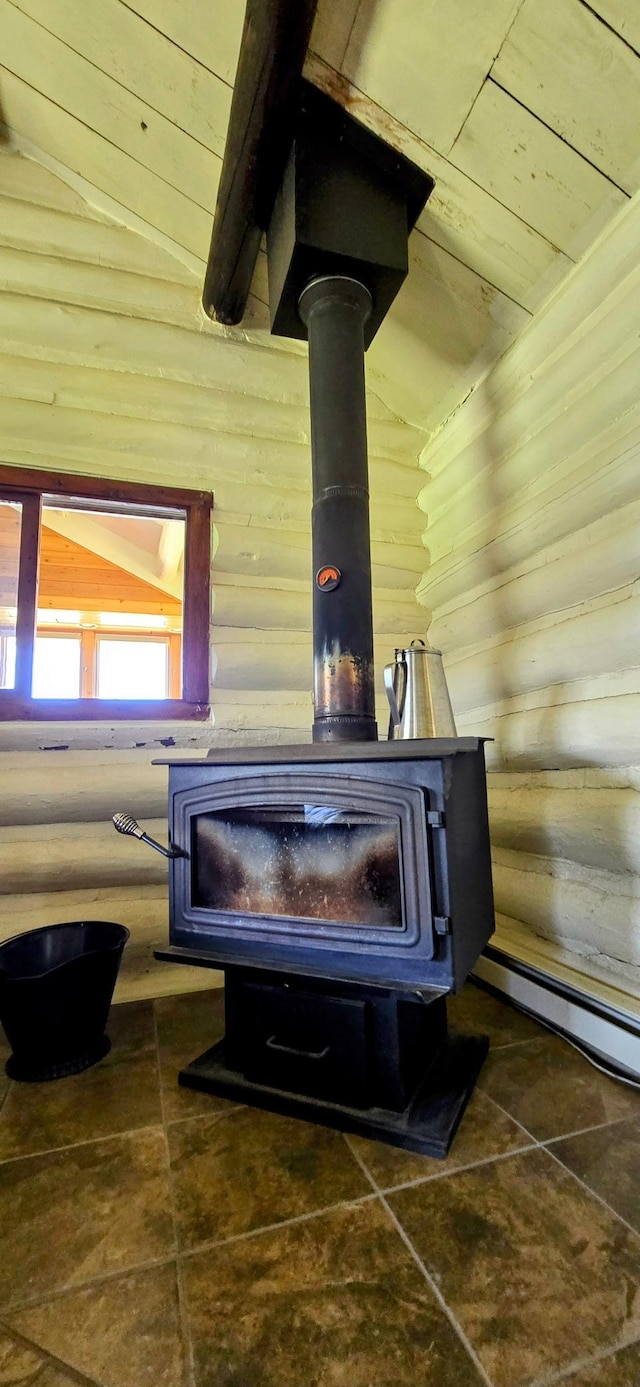 detailed view of a wood stove, wood walls, and wooden ceiling