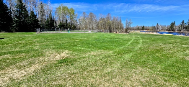 view of home's community featuring a water view and an area for soccer