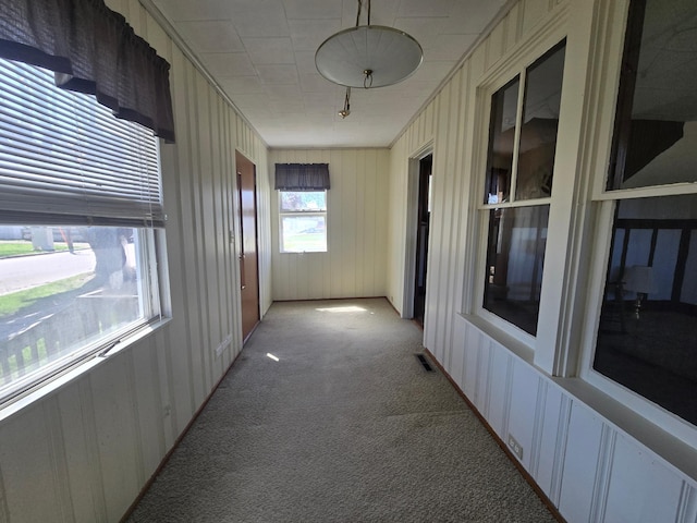 corridor featuring light carpet and visible vents